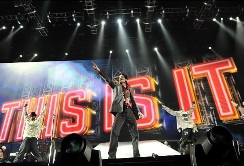 Michael Jackson stands in front of the "This Is It," light marquee. Love Lives Forever.
