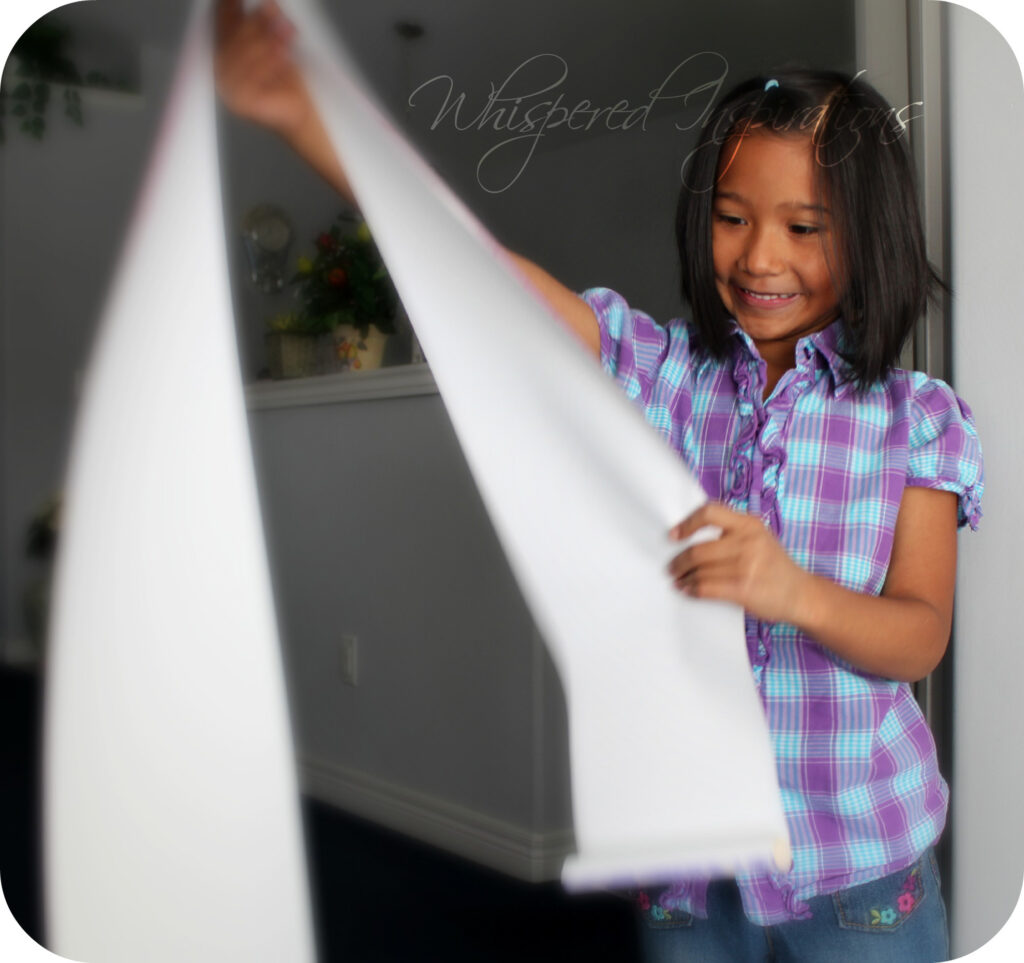 She smiles as she looks at the growth chart. 