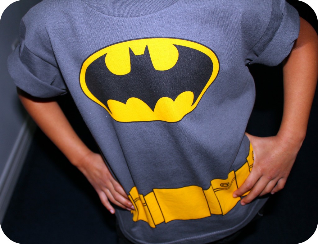My Little Superhero. A girl shows off her batman shirt.