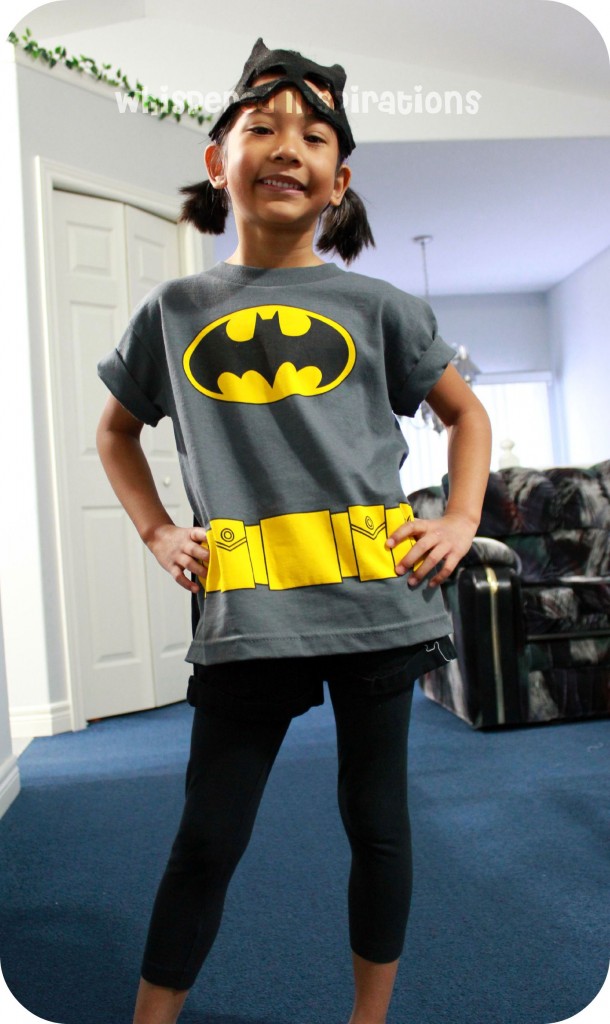 My Little Superhero. A girl shows off her batman shirt.