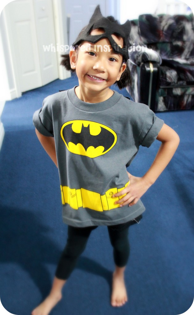 My Little Superhero. A girl shows off her batman shirt.