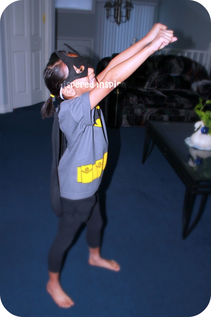 My Little Superhero. A girl shows off her batman shirt.