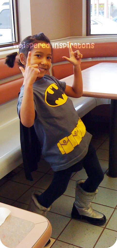 My Little Superhero. A girl shows off her batman shirt.