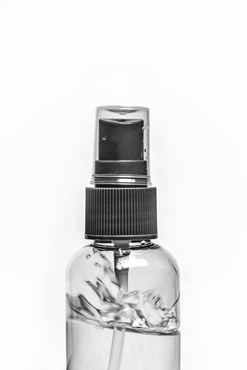A spray bottle filled with clear liquid.