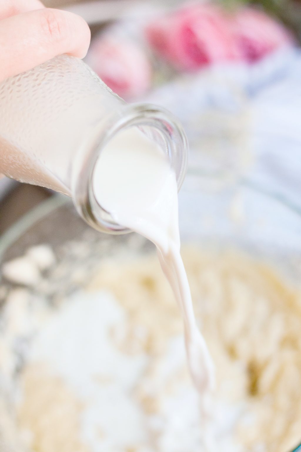 Milk is poured onto mixture in a bowl. 