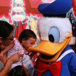 Donald duck and Mimi kissing him on the beak. 