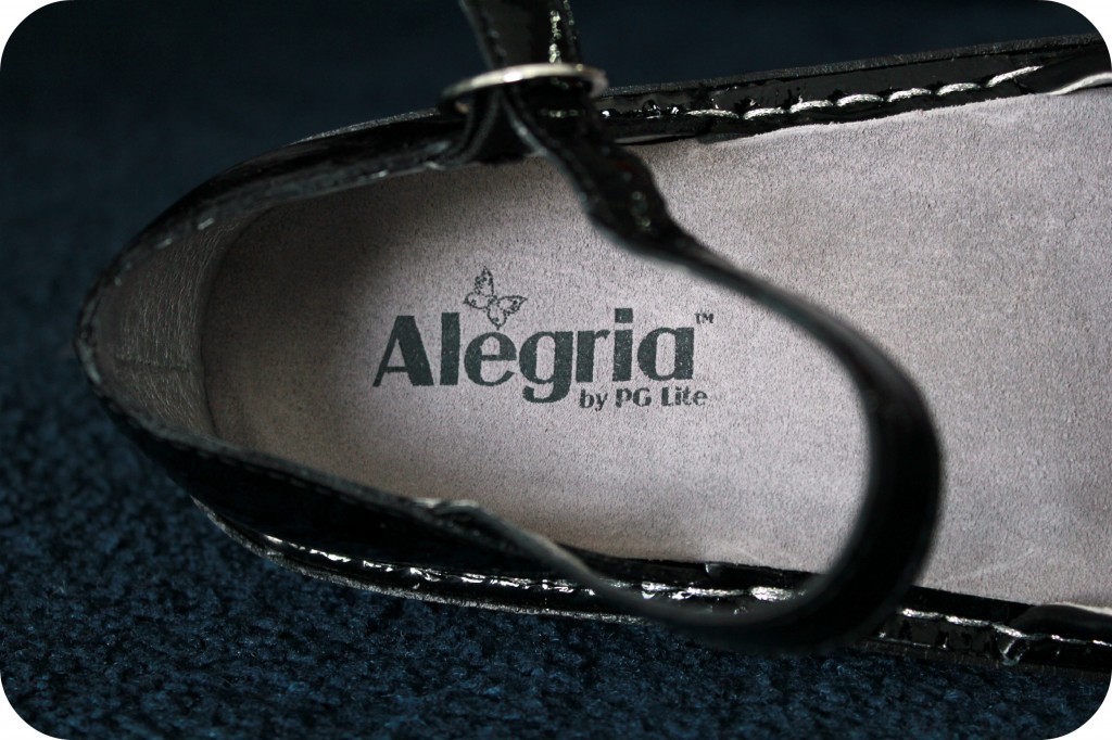 A close of up of the Alegria logo is shown inside the shoe.