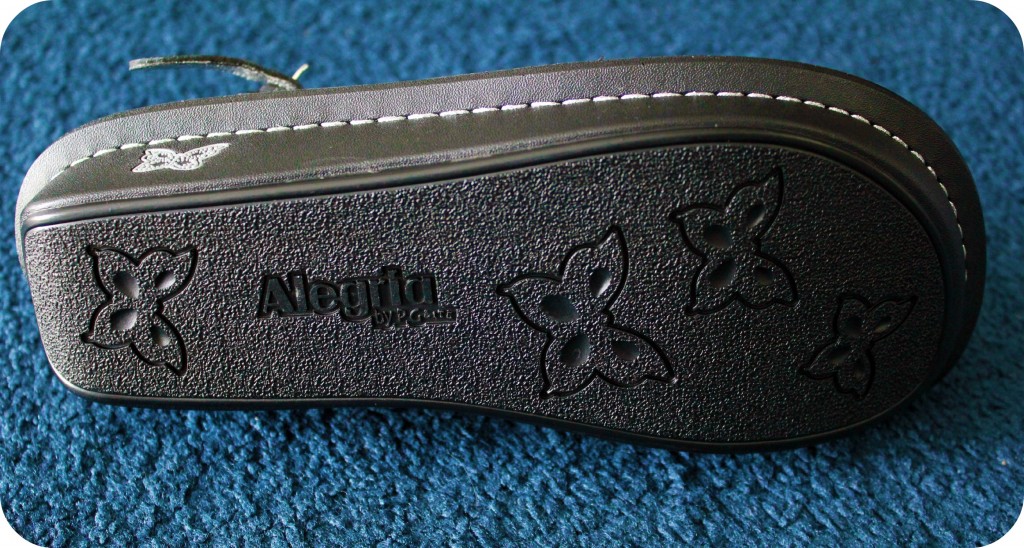 A shoe lays on its side, showing the sole.