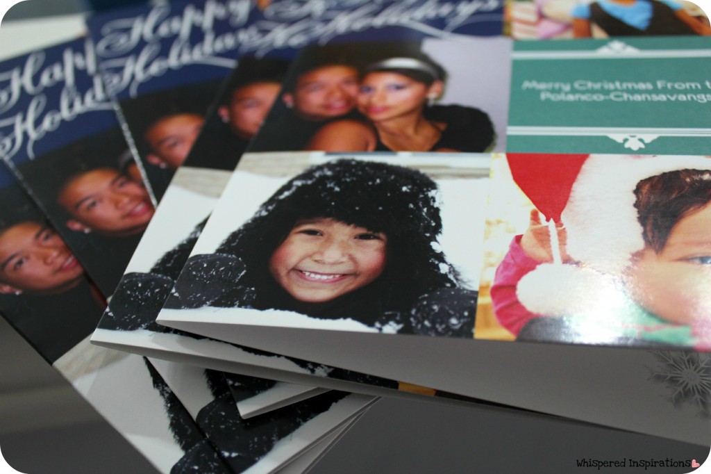 A stack of Christmas card that are personalized.