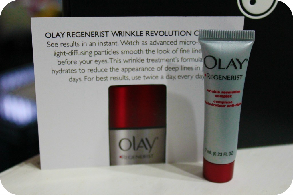 Olay Regenerist Wrinkle Cream in front of a informative post card. 