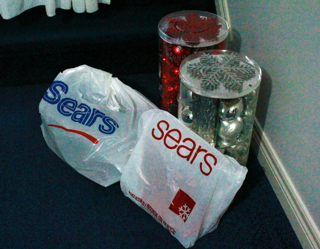 Sears bags filled with tree trimming decorations.