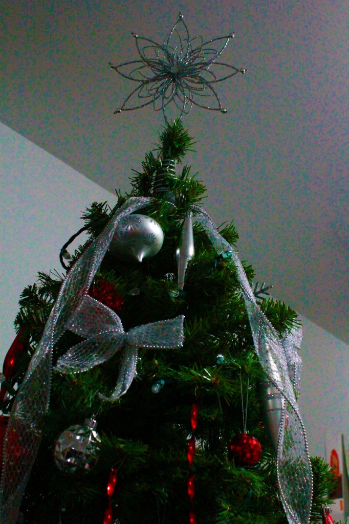 A star is shown on top of a Christmas tree. 