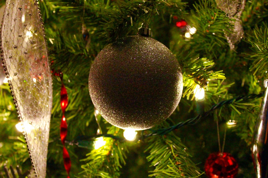 An ornament is shown lit up on the Christmas tree. 