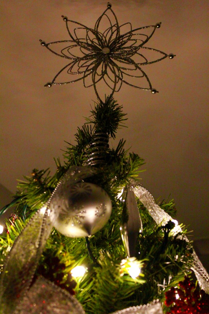 The star at the top of a Christmas tree. 