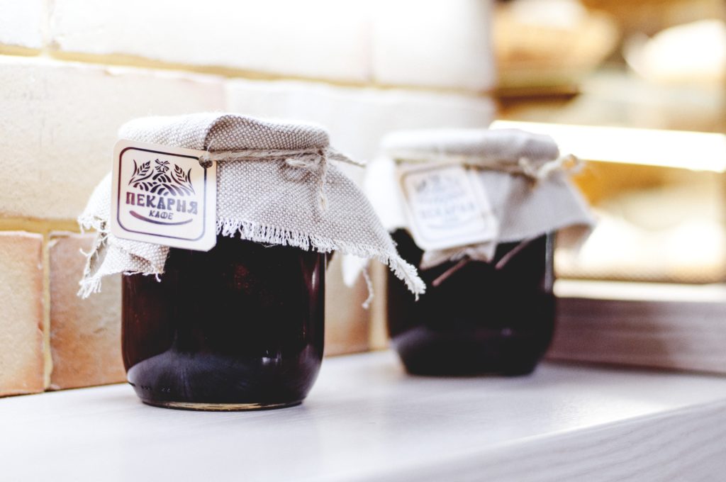 Homemade jam in mason jars and decorated to gift. 