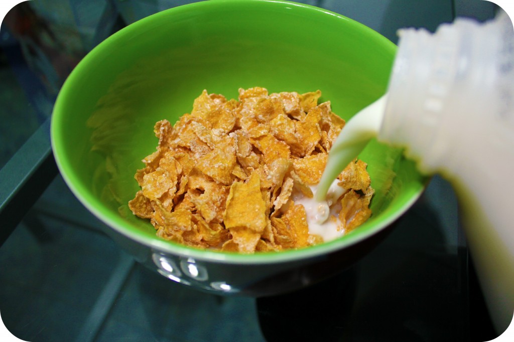 Milk pouring into Frosted Flakes.