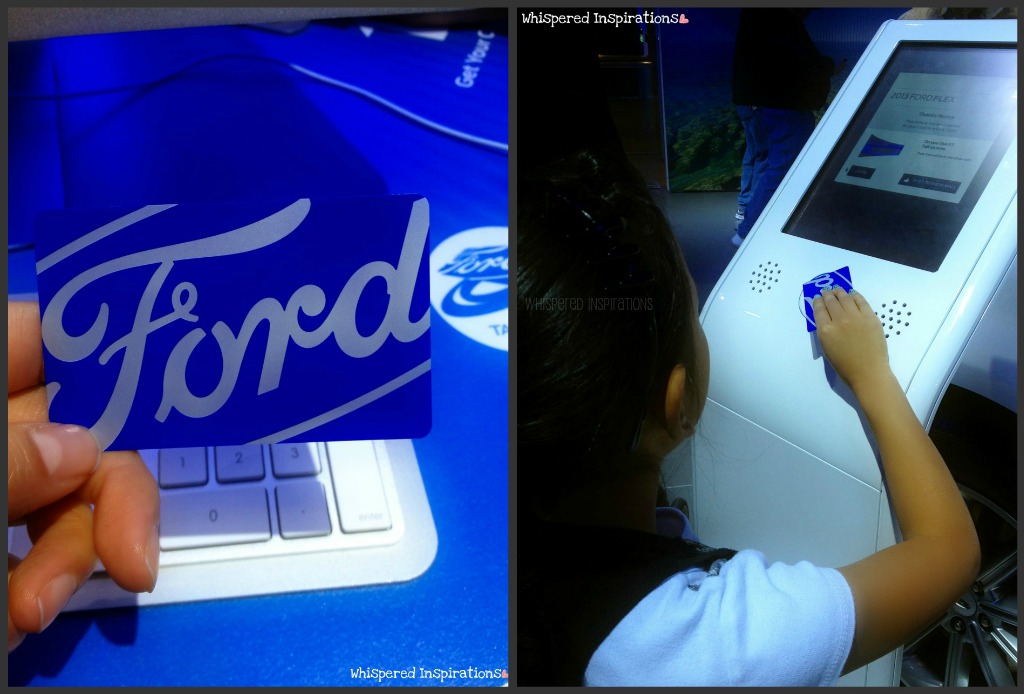 A little girl scans a card at the Auto Show at the Ford booth.