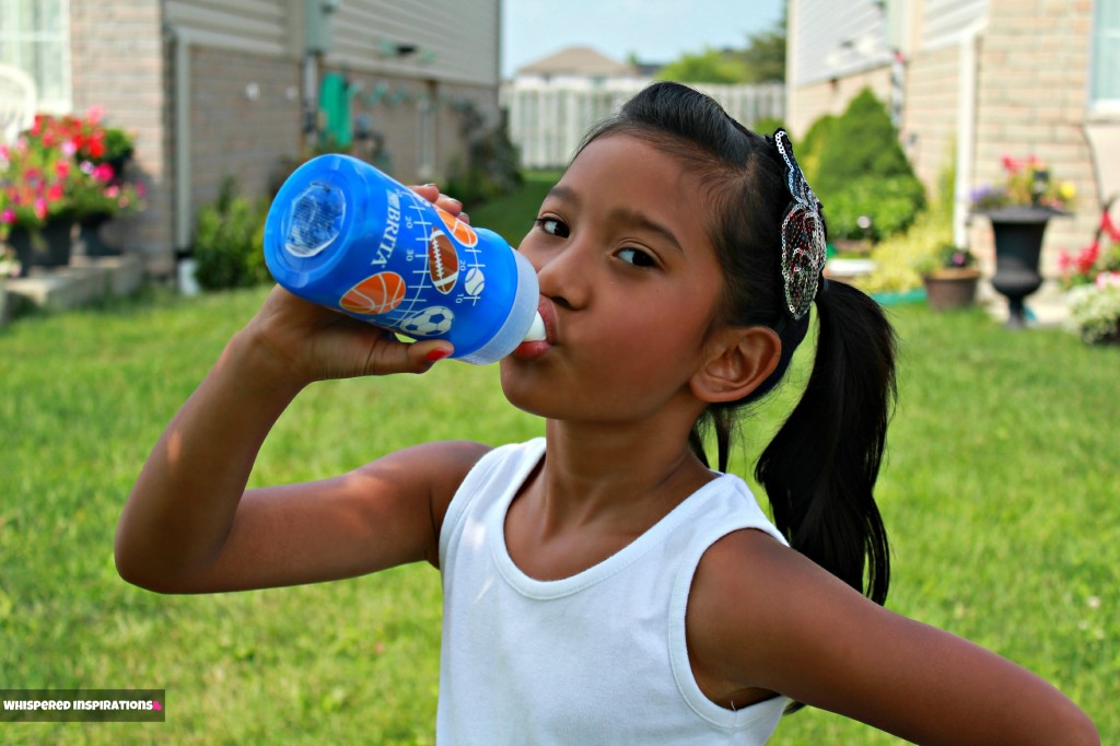 Gabby holds Brita bottle as she drinks.