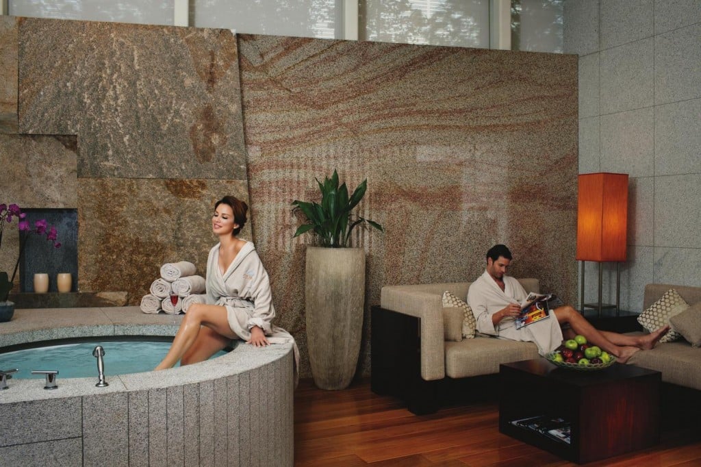 A couple enjoy their room with an in-suite spa.