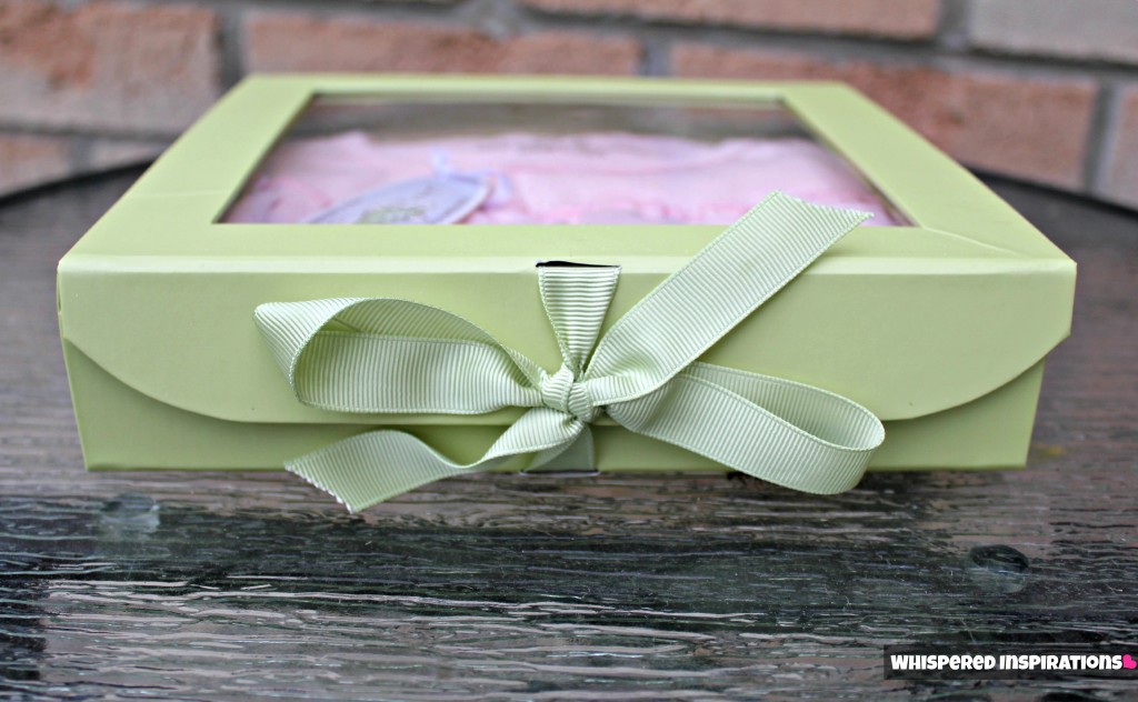 The organic dress in a pretty green box held closed by a green ribbon. 