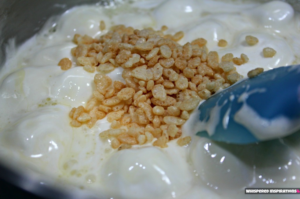 Rice Krispies being mixed into marshmallow and butter mixture. 