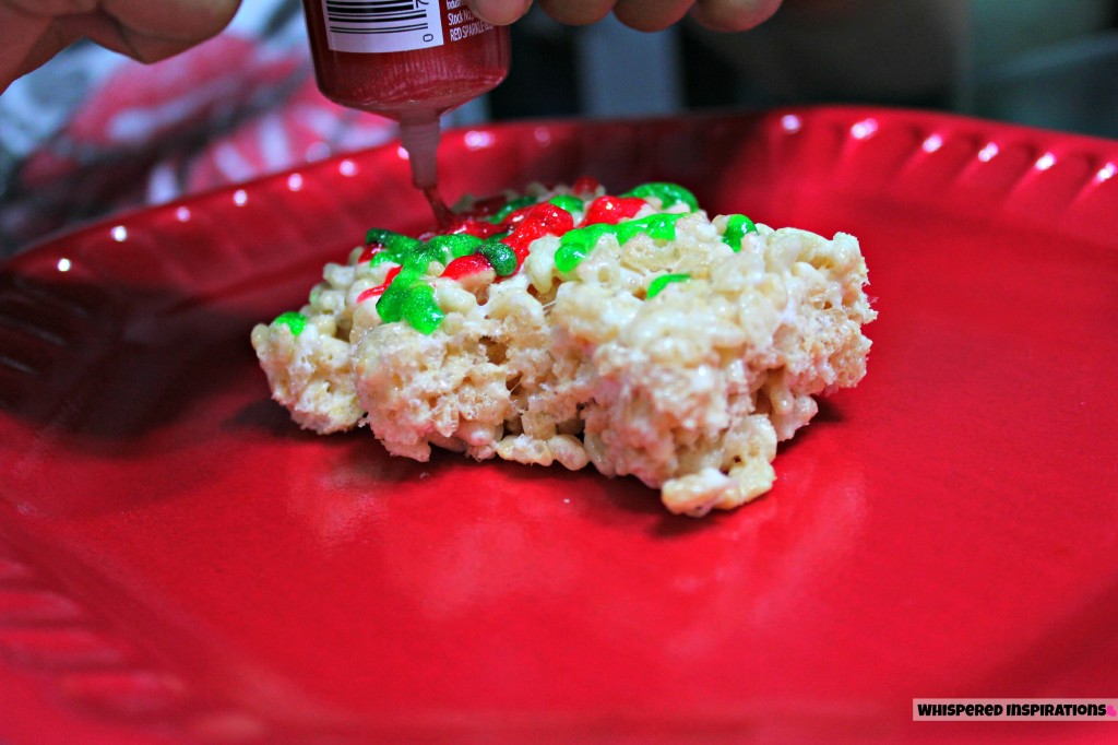 A little girl's hands are shown decorating Rice Krispie Treats!