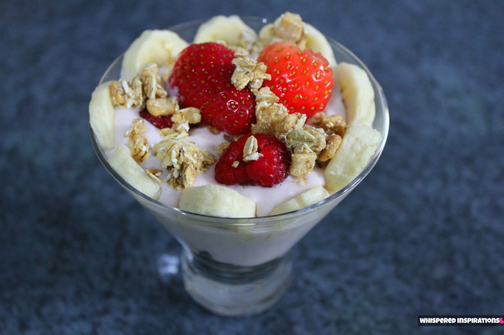 A fruit and yogurt parfait is shown. 