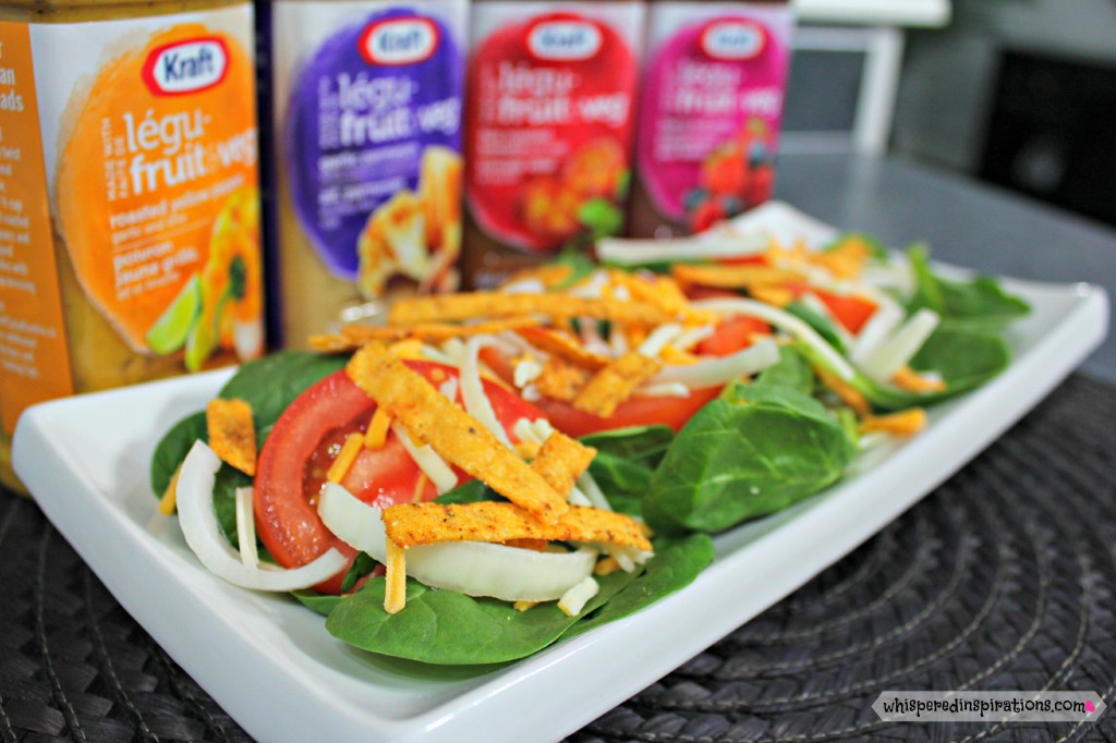 NEW Kraft Pourables stand next to each other and a skinny spinach salad is ready to be dressed. 