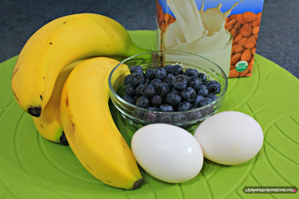 Almond milk, bananas, blueberrries, and egss are shown.