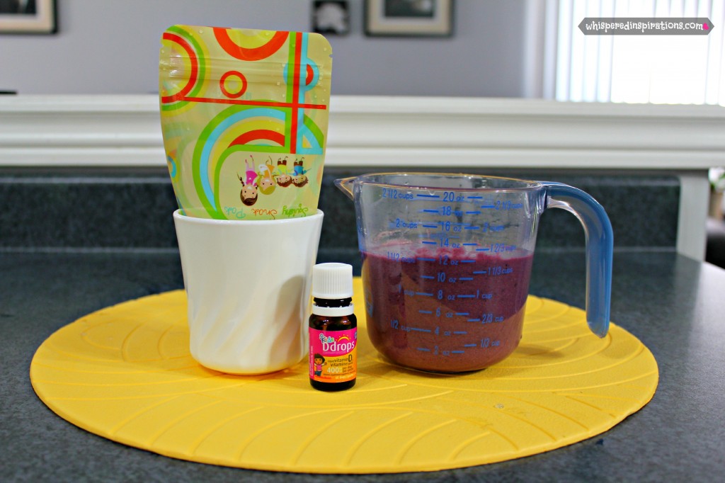 A measuring cup filled with fruit mixture to pour into Squishy Snak Pak.