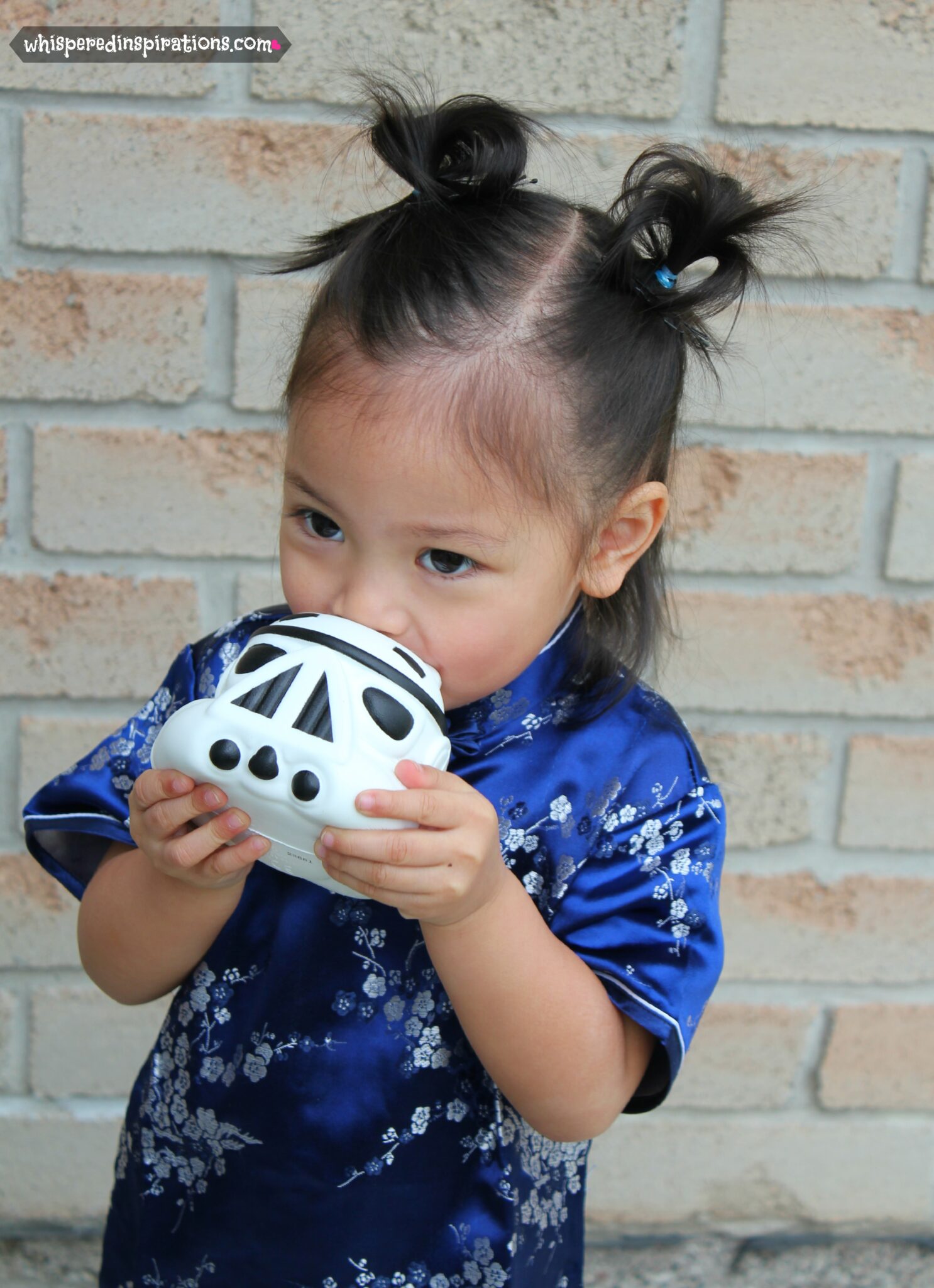 Mimi is kissing her Angry Birds pig dressed as a stormtrooper.