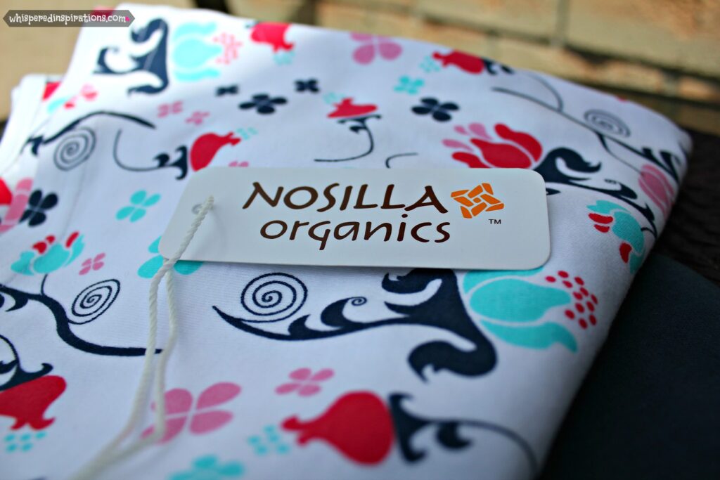 The dress is folded and shows the tag with Nosilla Organics. 