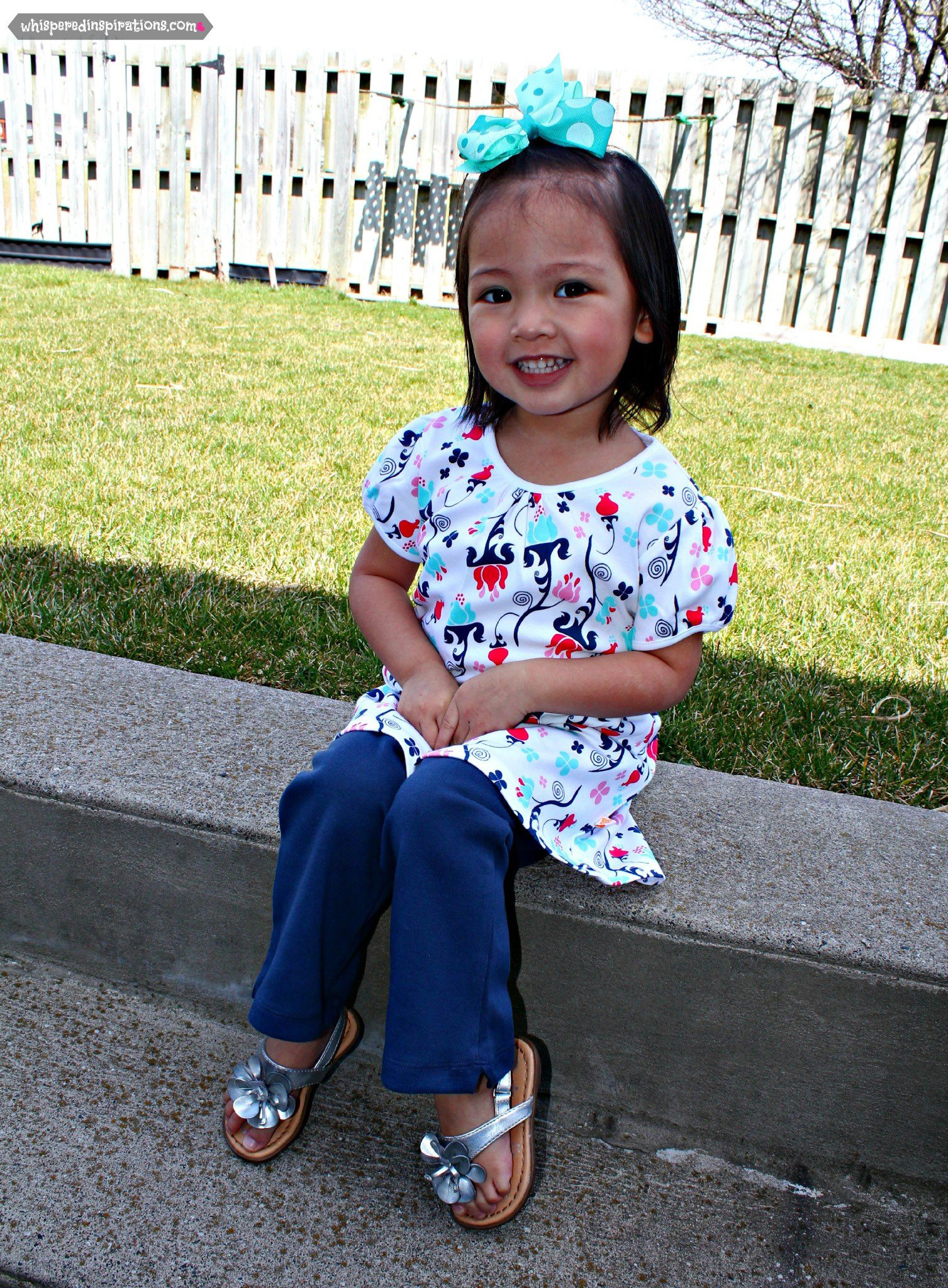 Mimi sits and poses while showing off her new outfit. 