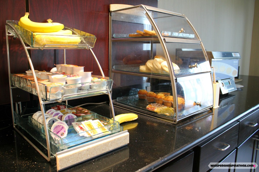 The Holiday Inn Express breakfast area, bananas, pastries, and jams are stocked for guest to enjoy.