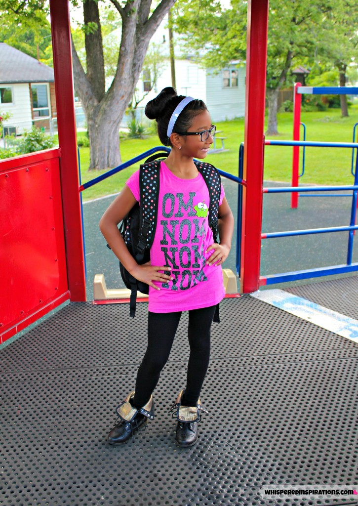 Little girl posing in her first day school outfit from Sears. 