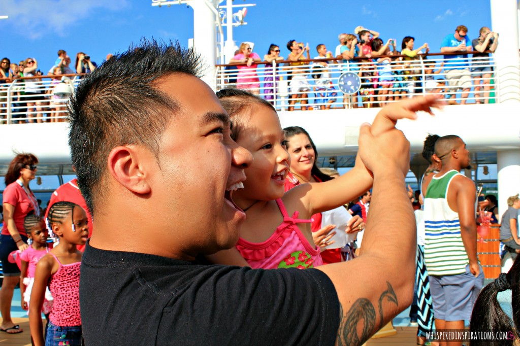 A little girl dances with her dad at Disney Dream Sail Away party. 