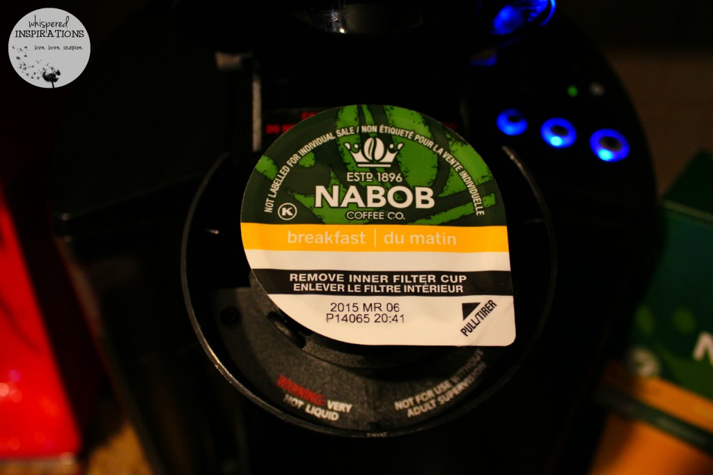 Close up of Nabob k-cup inside the Keurig machine.