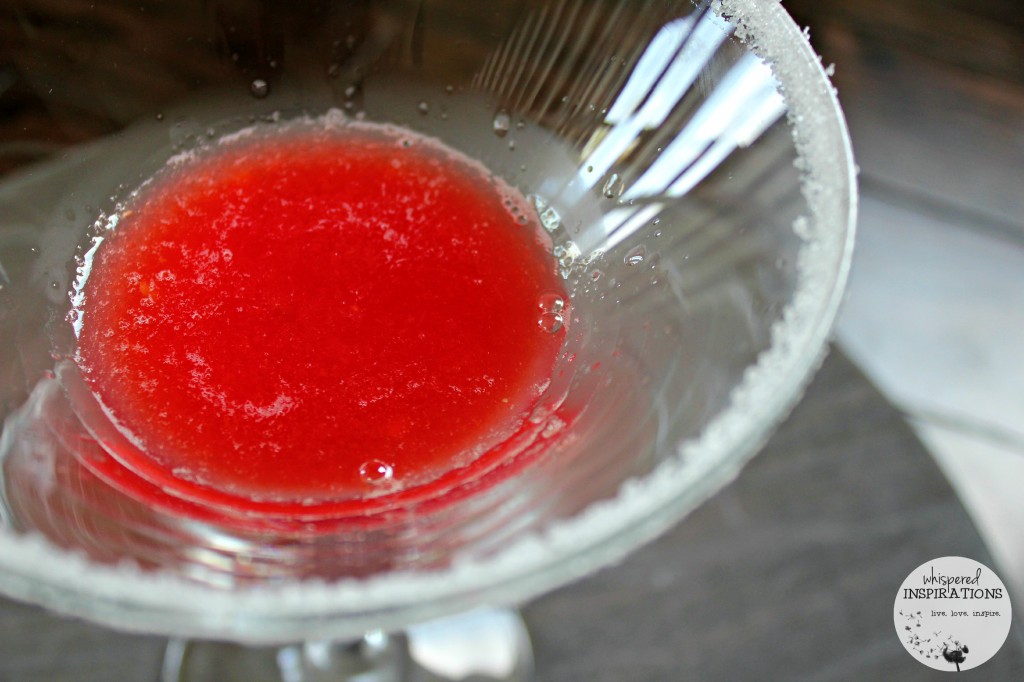 Strained watermelon juice at the bottom of a martini cup. 