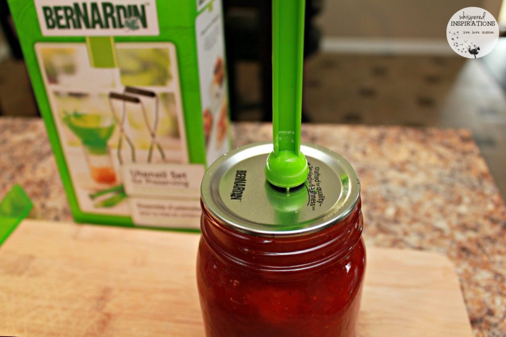 Putting on the lids before they are sealed with water. 