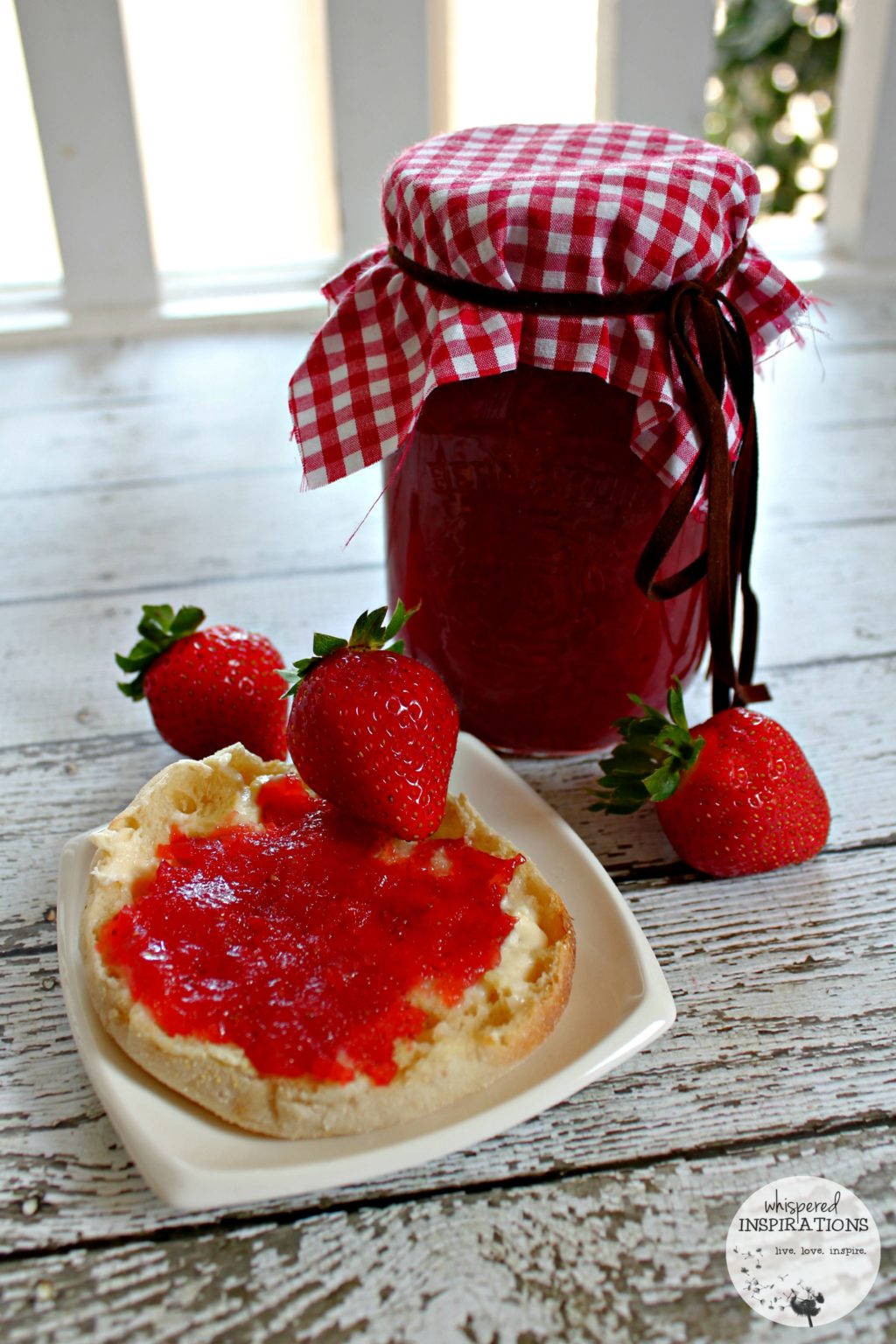 Another view of the strawberry jam on a buttered English muffin. 
