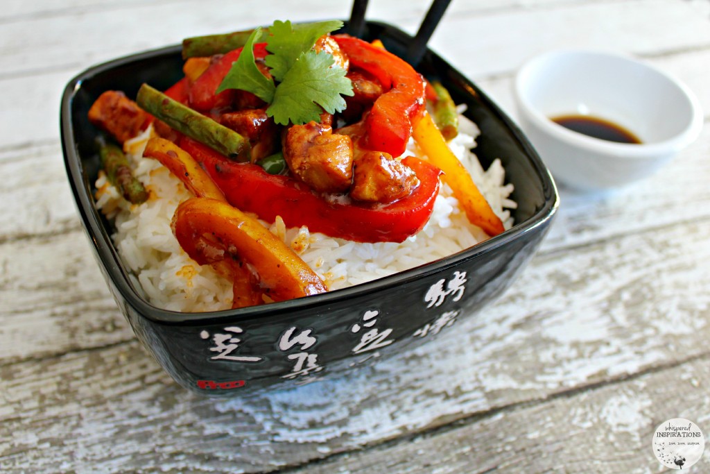 The finished product, the chicken and veggie mix is topped on a bed of white steamed rice. 