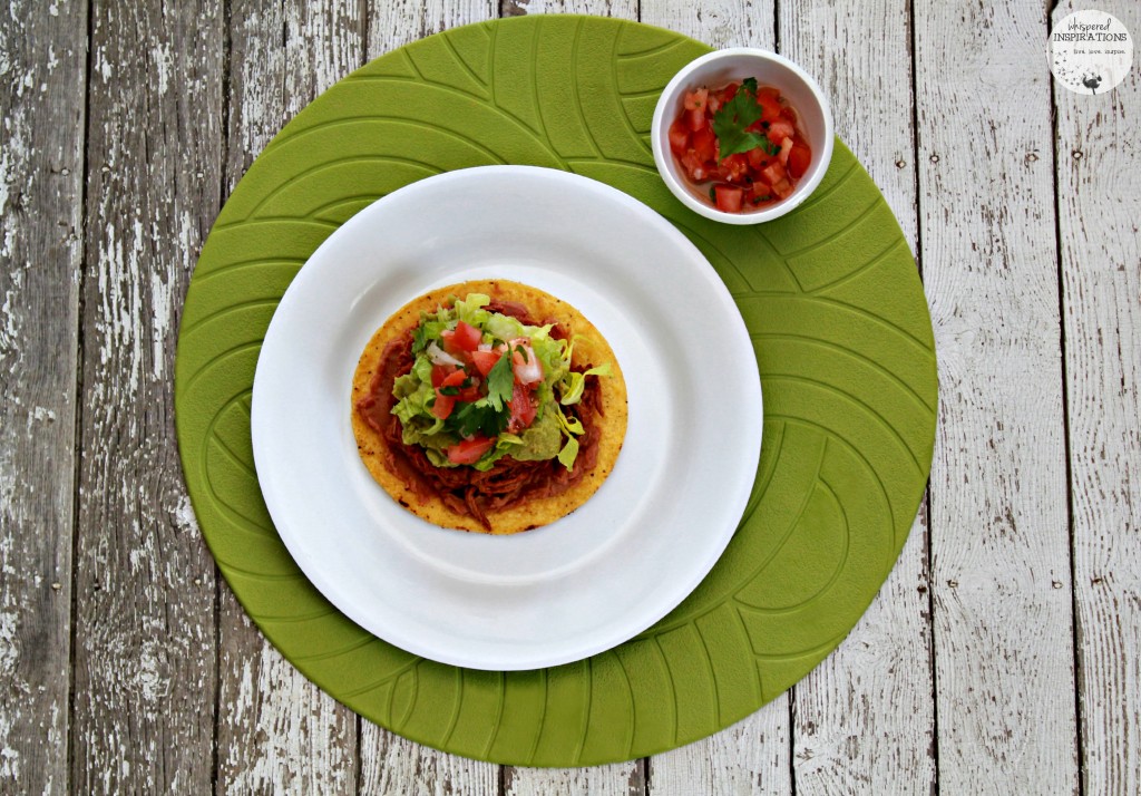 An aerial view of a Salvadorean beef enchilada served with pico de gallo. 