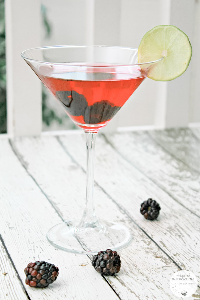 A red Valentine's Day cocktail with black berries.