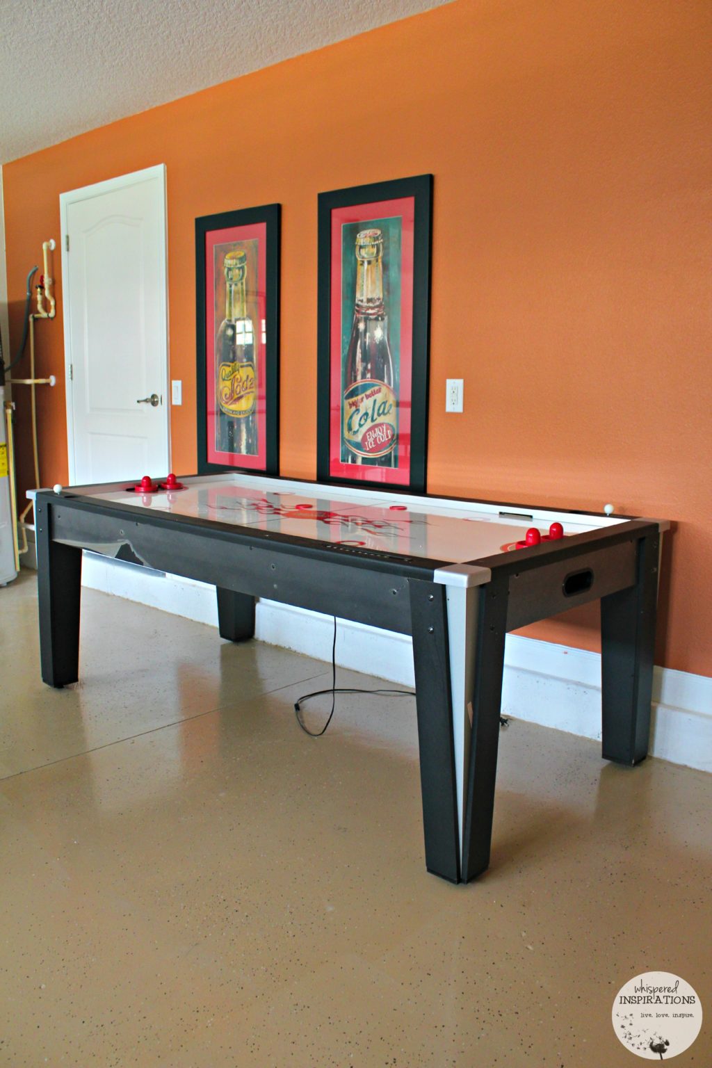 An air hockey table in a garage.