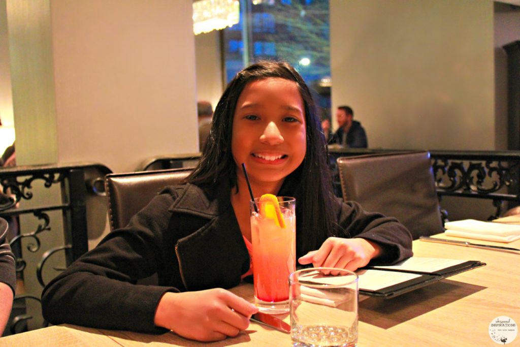 Gabby enjoying a Shirley Temple drink. This article covers dining at the Citrus Restaurant.
