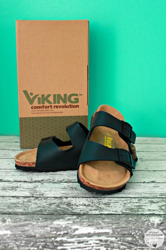 A pair of Viking Sandals leaning on each other, the box they come in sits behind it. 