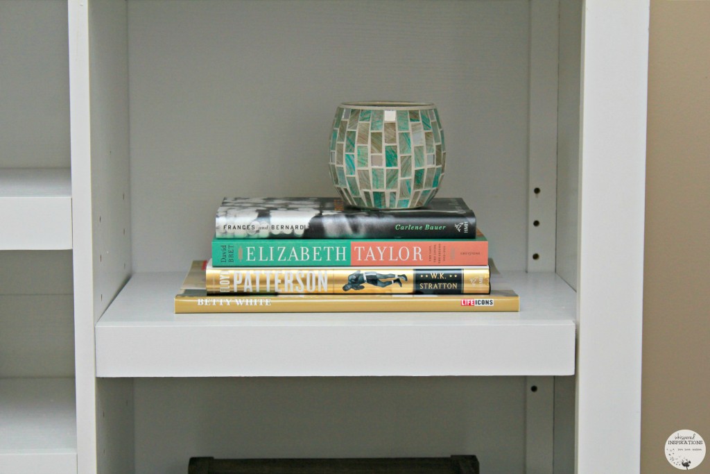 A stack of books in a book shelf.