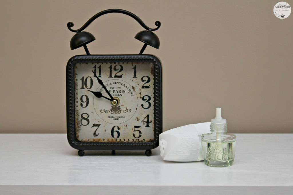 Clock with Air Wick next to it. 