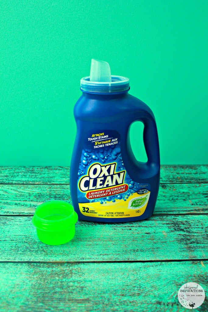 One of the top baby and child products. A bottle of OxiClean with a lid full of the clear liquid.