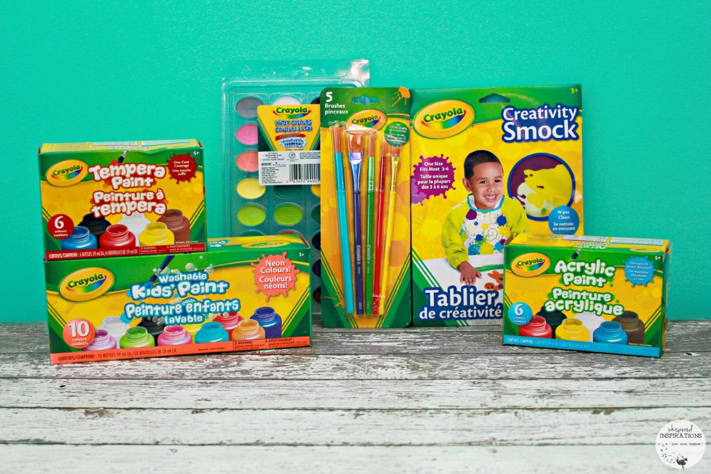 Crayola paint brushes, paint and paint smock are displayed against a teal background.